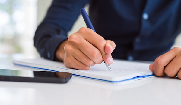 business man signing and reading new regulations